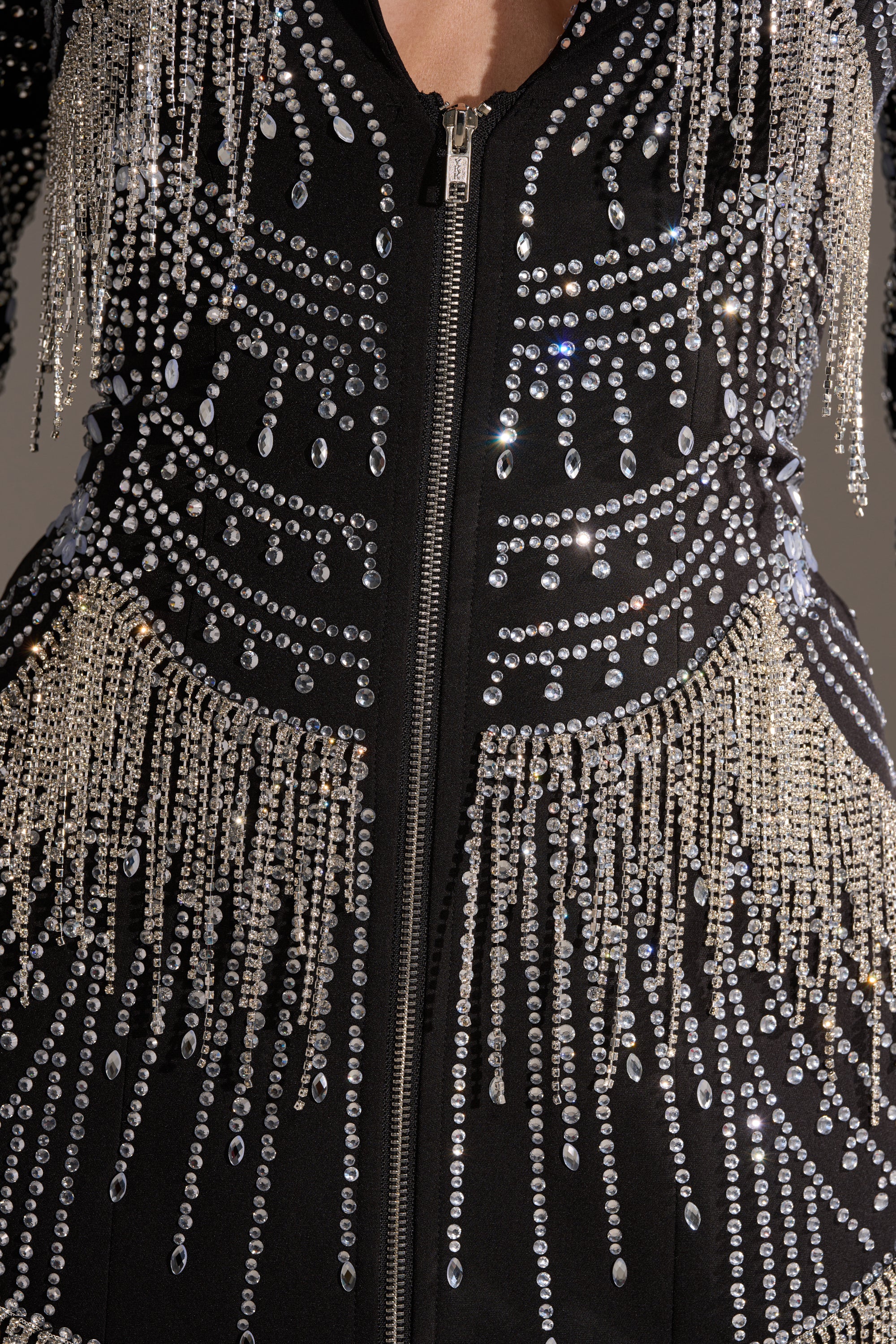 Close-up of the NOT YOUR BABE RHINESTONE BLAZER DRESS, showcasing a zipper and radiant patterns of sparkling rhinestone and bead fringe for a shimmering, glamorous effect.