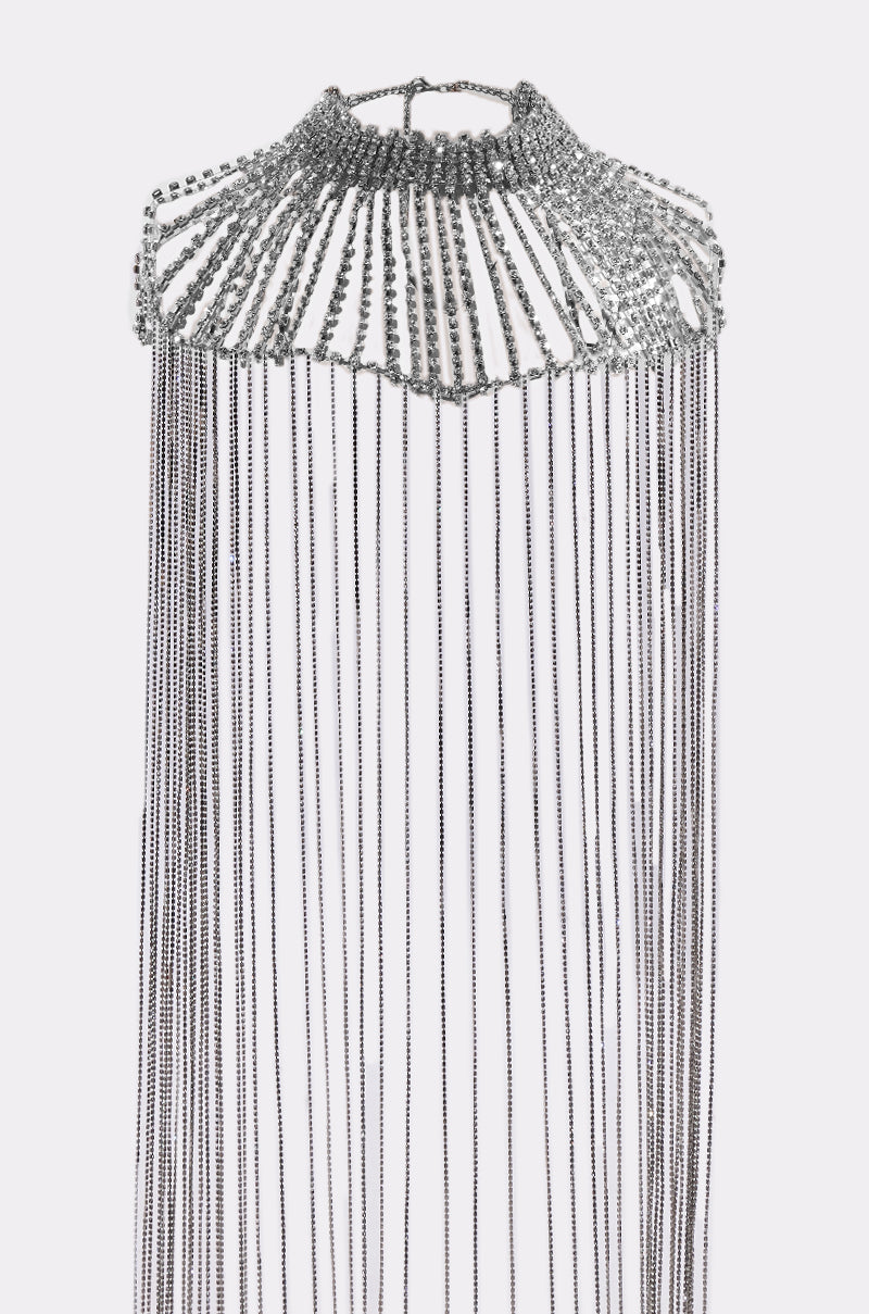 The TRU STATEMENT NECKLACE is a silver choker with an ornate design, rows of sparkling rhinestones at the top, and long, dangling silver chain fringe. 11