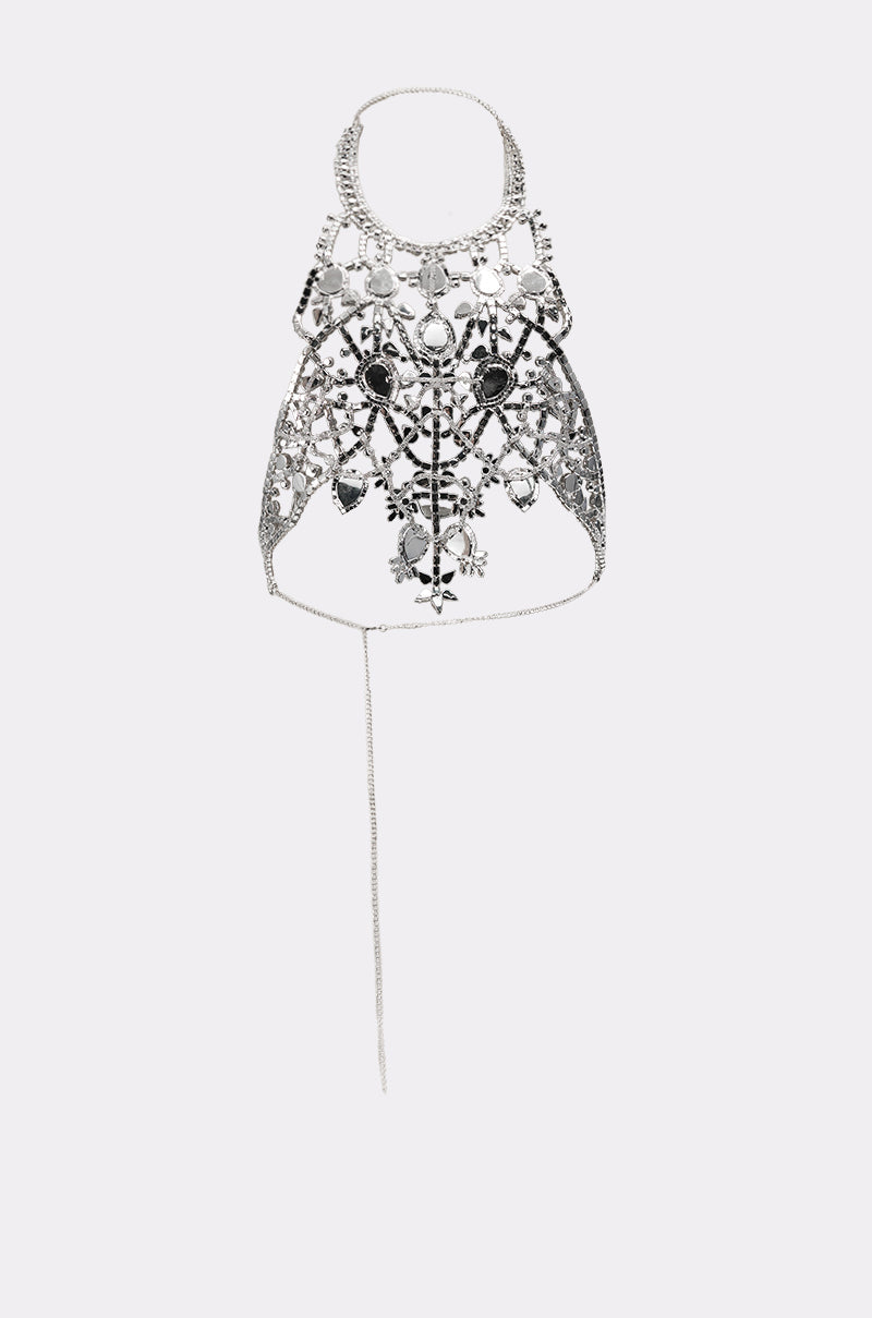 The IN YOUR DREAMS BODY CHAIN features a silver chest harness with intricate filigree, floral designs, gemstone accents, a choker neckline, structured centerpiece, and dangling chain—ideal as bold statement jewelry. 5