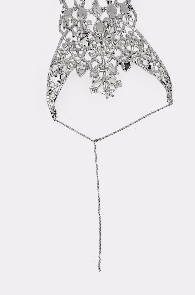 The IN YOUR DREAMS BODY CHAIN features an intricate silver chest piece with floral and geometric designs, forming a stunning statement jewelry body chain connected to a sleek silver chain—perfect for standout style. 6
