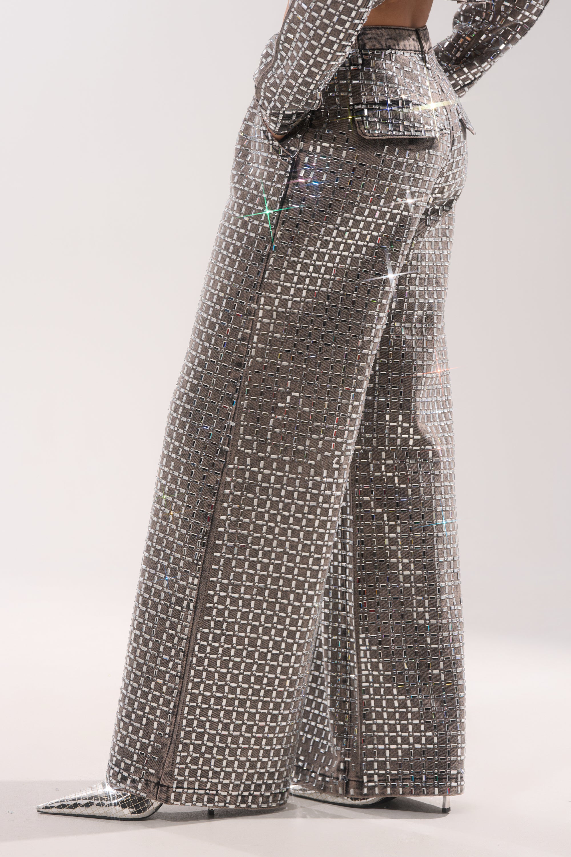 A person wears the PICK N CHOOSE Rhinestone Wide Leg Denim in Grey, featuring high-waisted, wide-leg jeans embellished with sparkling rhinestones—ideal for a chic evening look. 5
