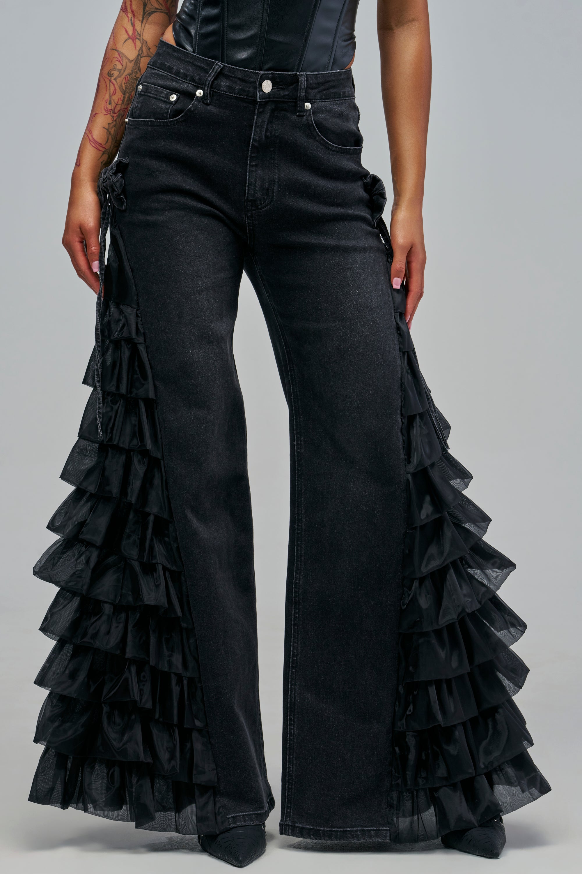 Black RUFFLE CITY STRAIGHT LEG DENIM IN BLACK jeans featuring layered ruffles down the outer side seams.