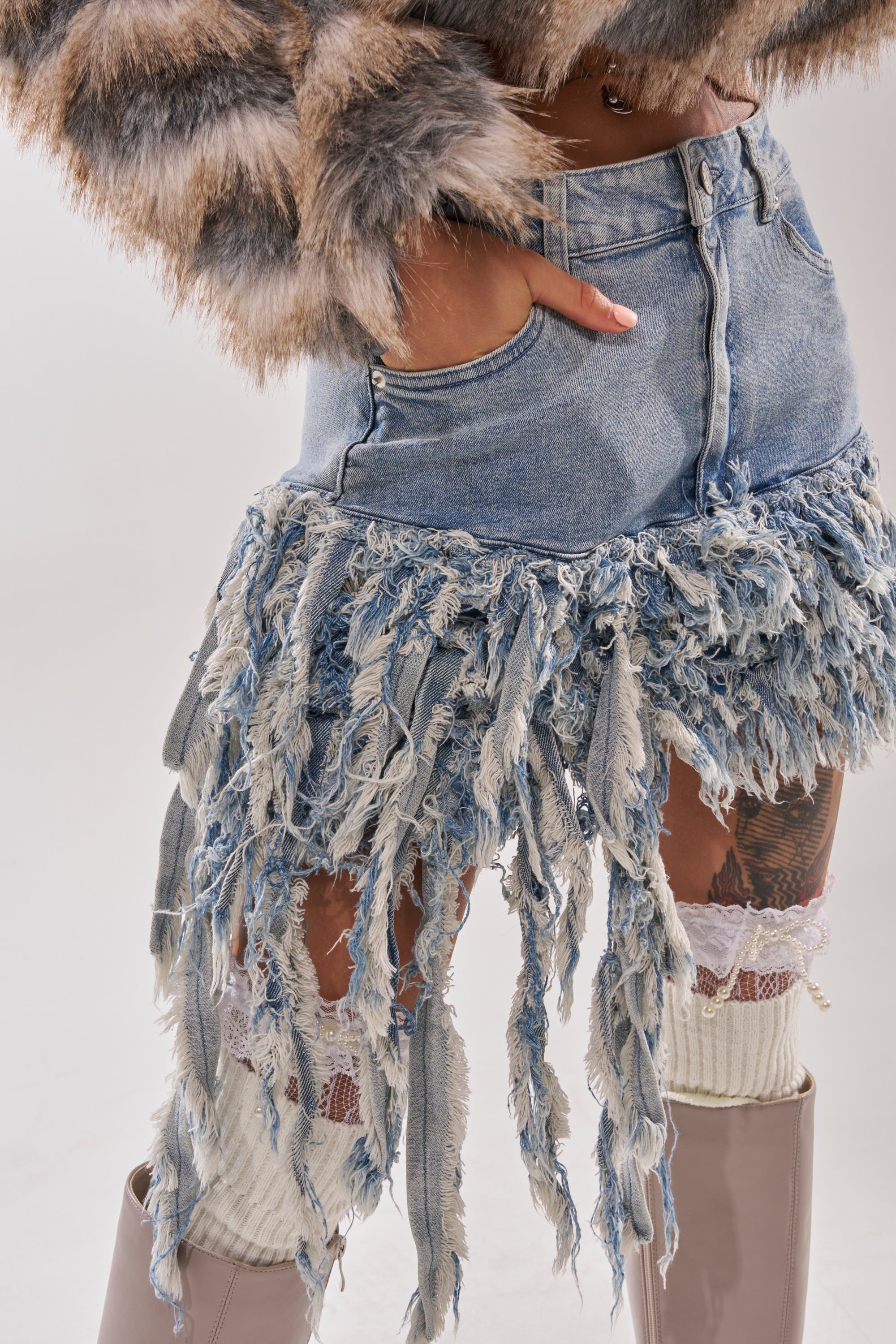 Wearing the OPEN UP YOUR LOVE DENIM SKIRT with a furry jacket, white lace-trimmed socks, and beige knee-high boots creates an eclectic look full of texture and bold style. 9