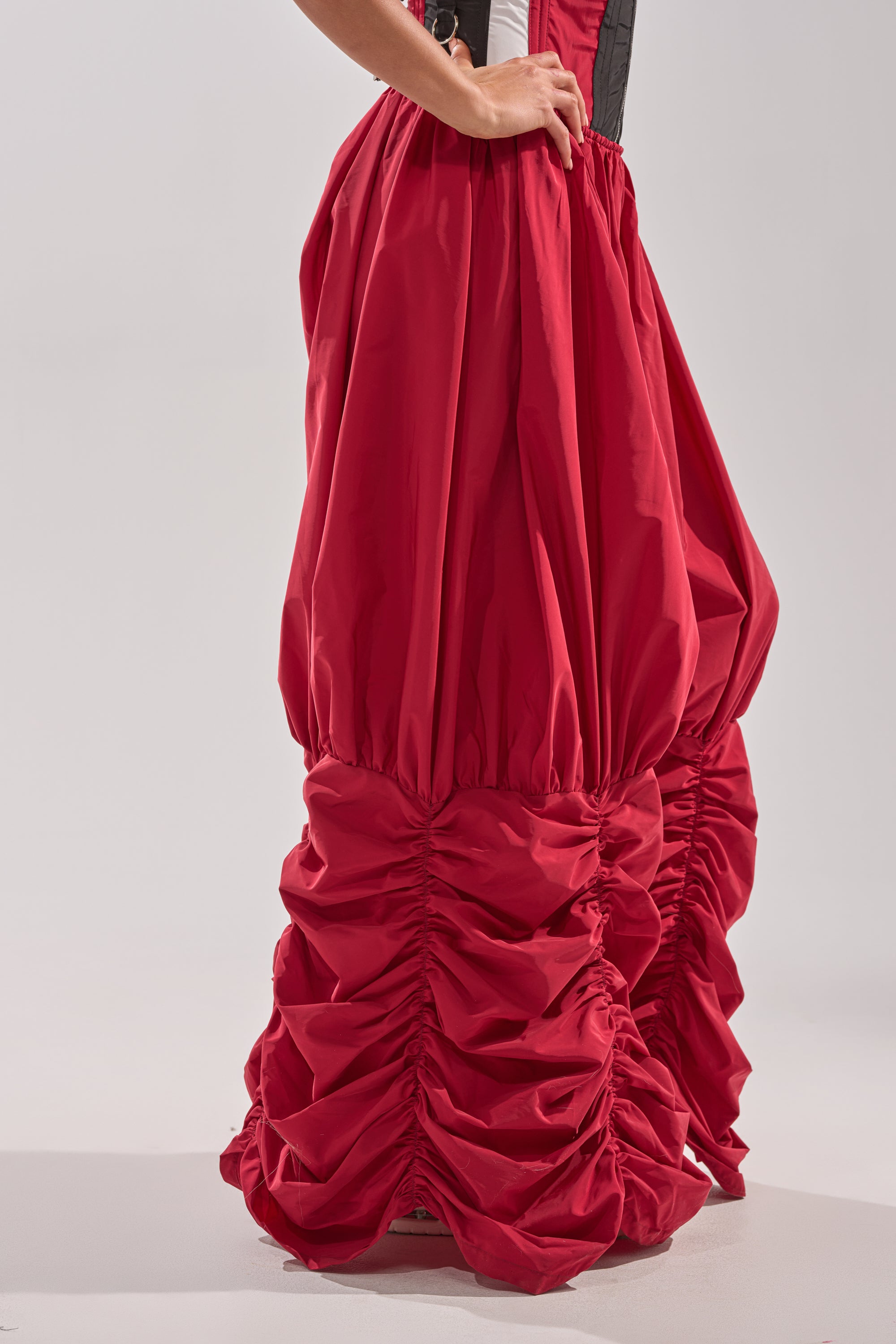 A person models the DON'T MIND ME STACKED JOGGER—dramatic, voluminous red pants gathered at the ankles—paired with a black and white top, shown waist down. 4