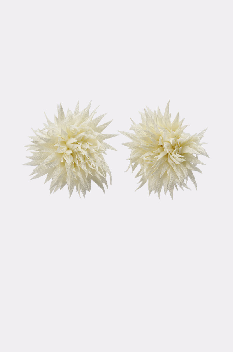 The LALA LAND EARRING features two cream-colored artificial flowers with pointed white fabric petals, displayed side by side on a plain white background. 2