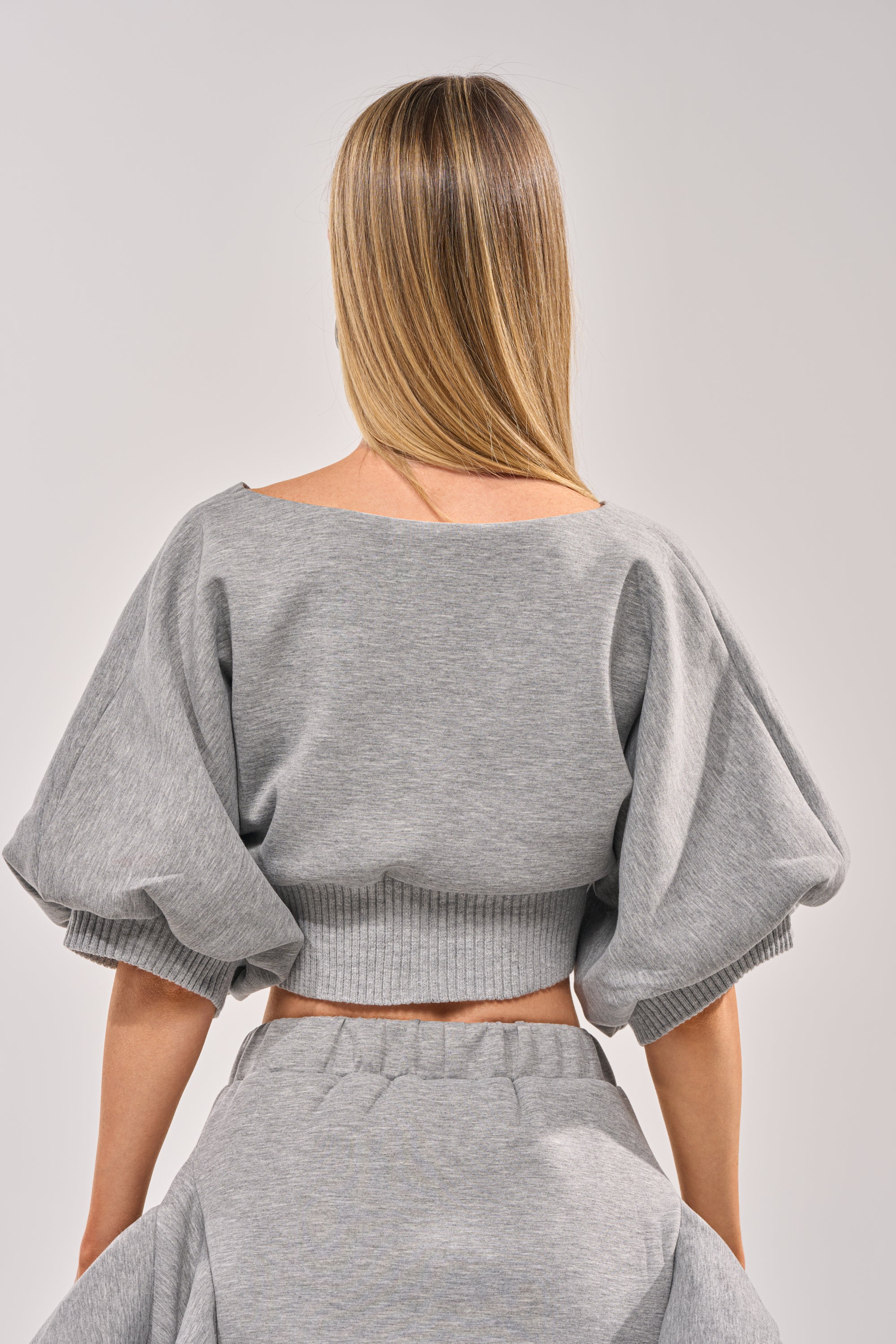 A woman with straight, light brown hair is seen from behind wearing the NO WORK ALL PLAY SCUBA SWEATSHIRT in grey. The streetwear style stands out against a simple light gray background. 4