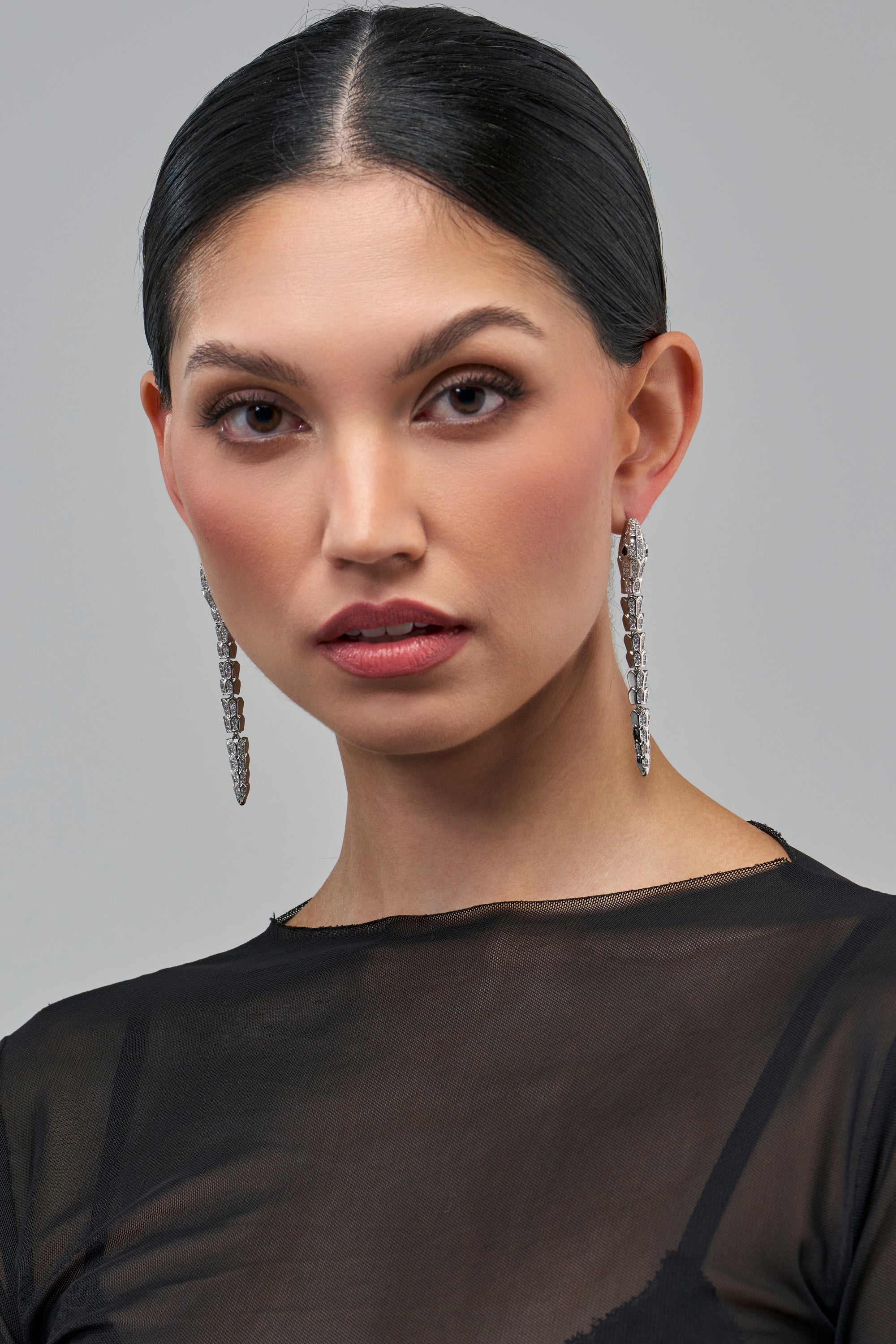 Model wearing DON’T BE A SNAKE EARRING, featuring long, dangling silver snake earrings with rhinestone detailing.