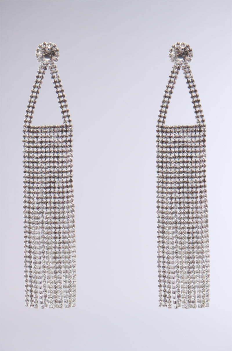 The EMBELLISHED CHANDELIER EARRINGS feature a cascading fringe of sparkling rhinestones, creating a breathtaking appearance against a plain background that perfectly complements an evening gown.