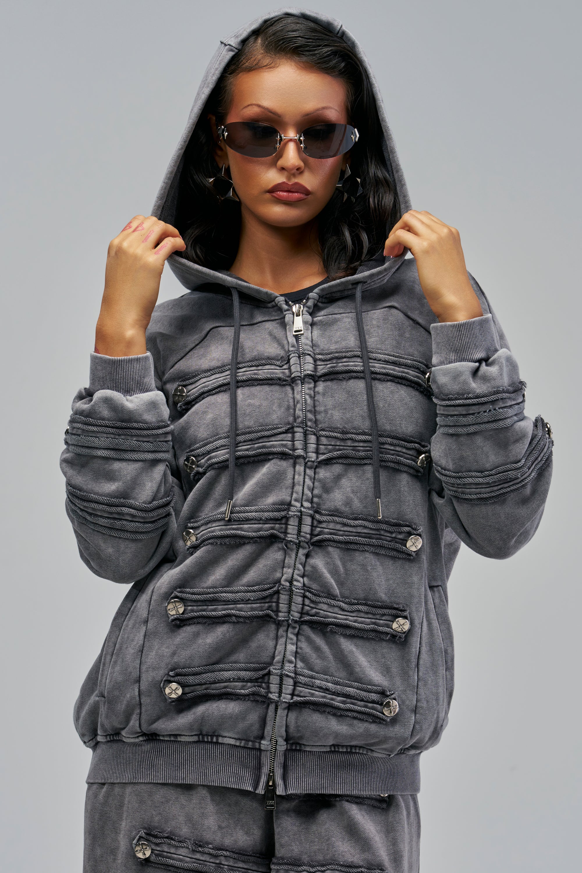 MEET ME AT THE TOP MINERAL WASH SWEATSHIRT is an oversized charcoal mineral wash zip-up hoodie featuring decorative horizontal cord detailing and silver buttons across the front.