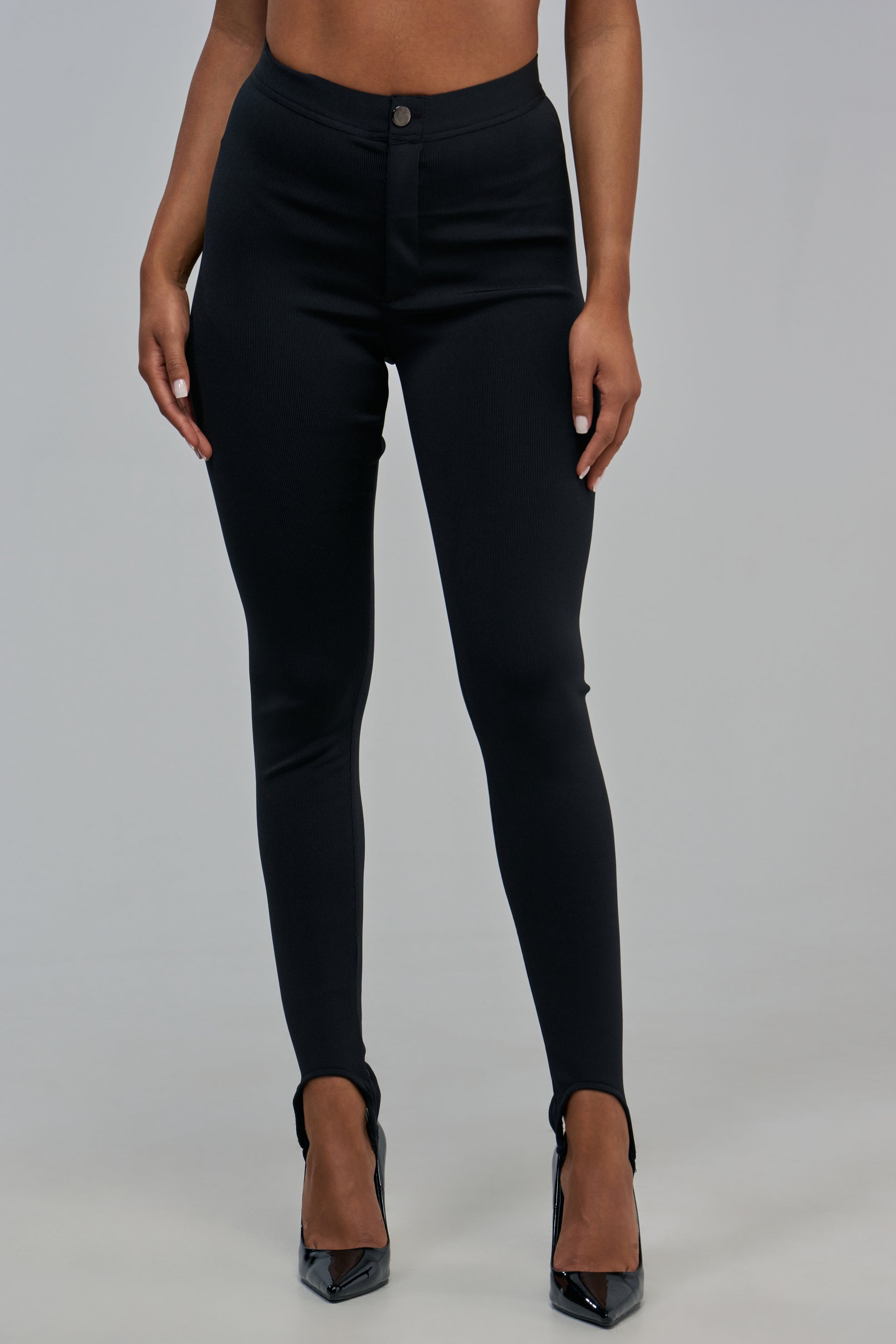 COOL GIRL BANDAGE STIRRUP LEGGING in black with a high-waisted, skinny-leg silhouette.