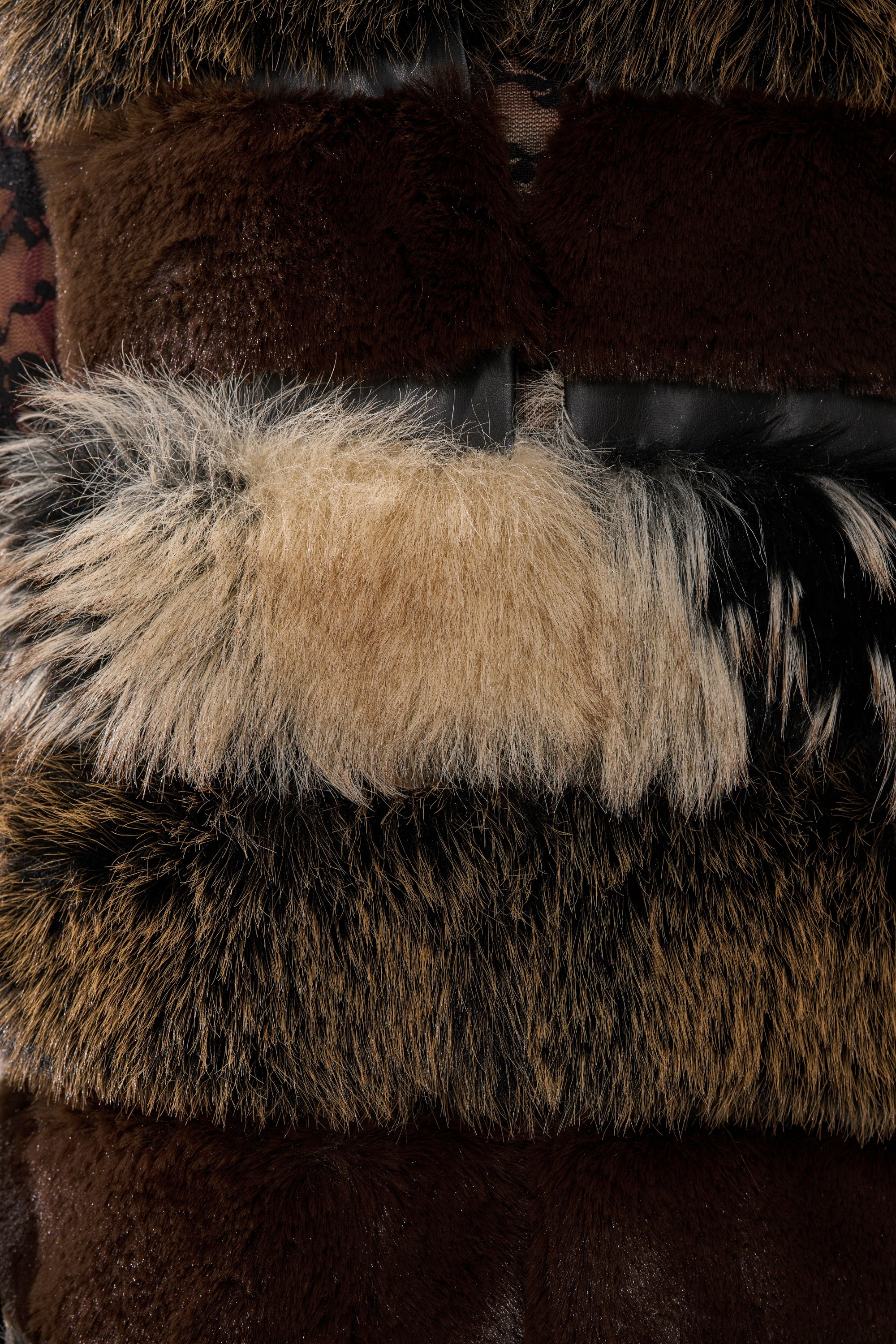 A close-up of the PORTIA PANELED FUR VEST highlights its plush faux fur texture—a standout statement piece for any wardrobe.