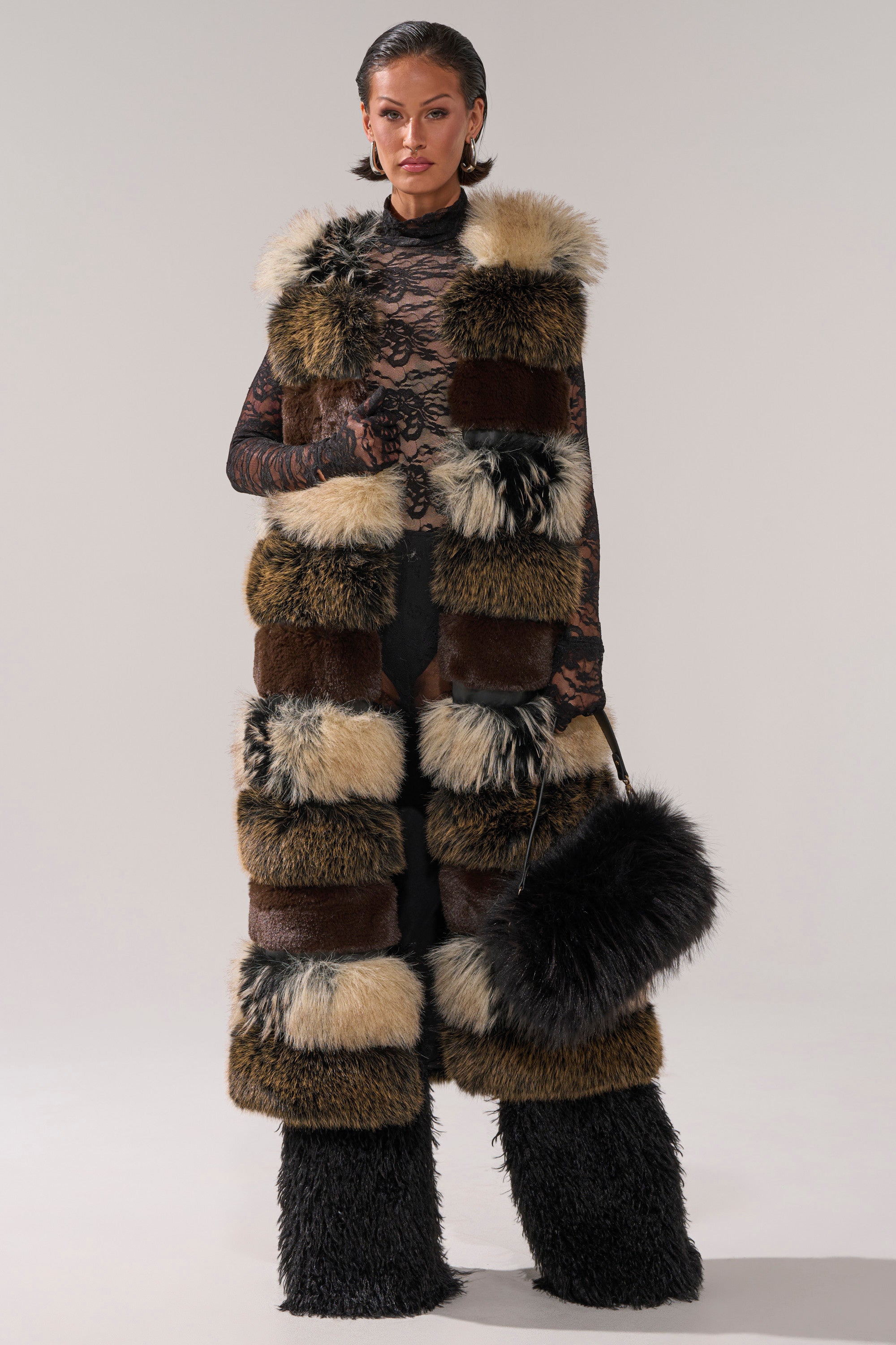 A woman wearing the PORTIA PANELED FUR VEST.