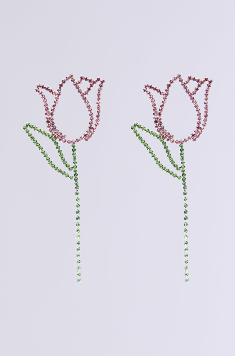Two minimalist TULIP TIME EARRING designs feature pink rhinestones for petals and green ones for stems, symmetrically arranged on a light gray background, offering springtime chic.