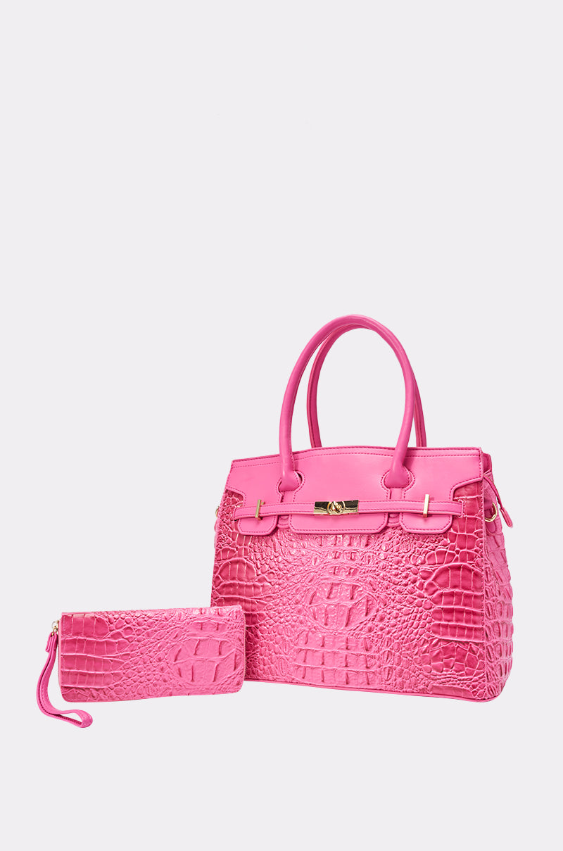 The PRETTY IN PINK TOTE, a vibrant pink croc faux leather bag with gold hardware, is shown with a matching zippered clutch on a plain light gray background.