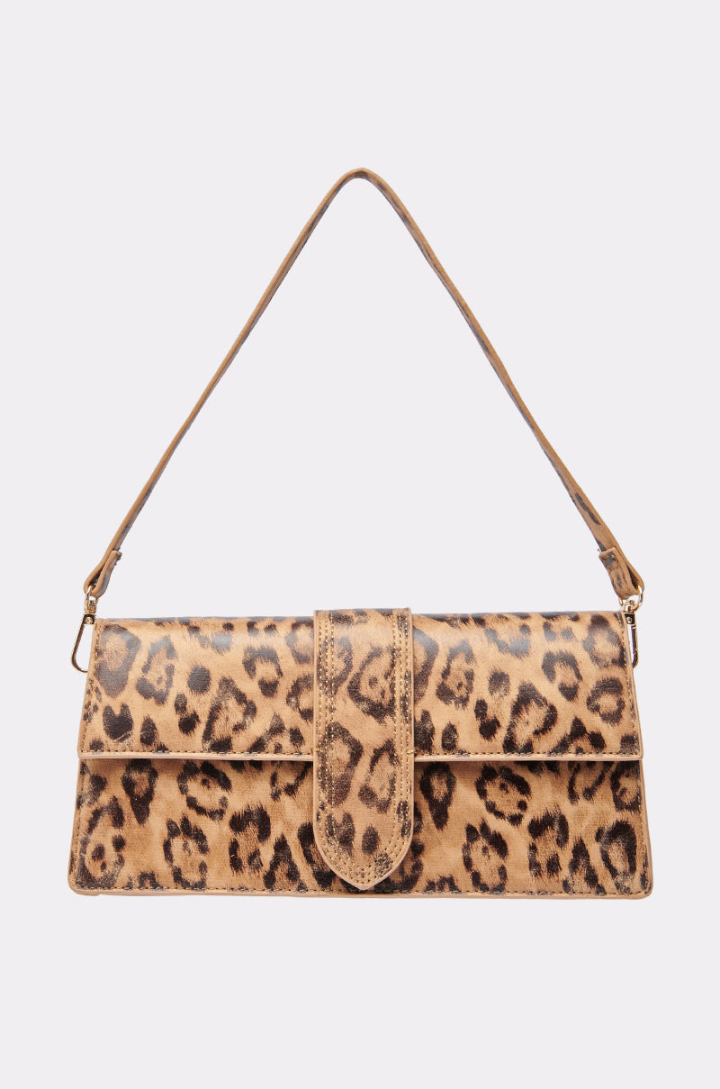 The CAN'T BE TAMED LEOPARD PRINT PURSE features a rectangular shape, front flap closure, matching strap, and crossbody design. Displayed on a plain white background.