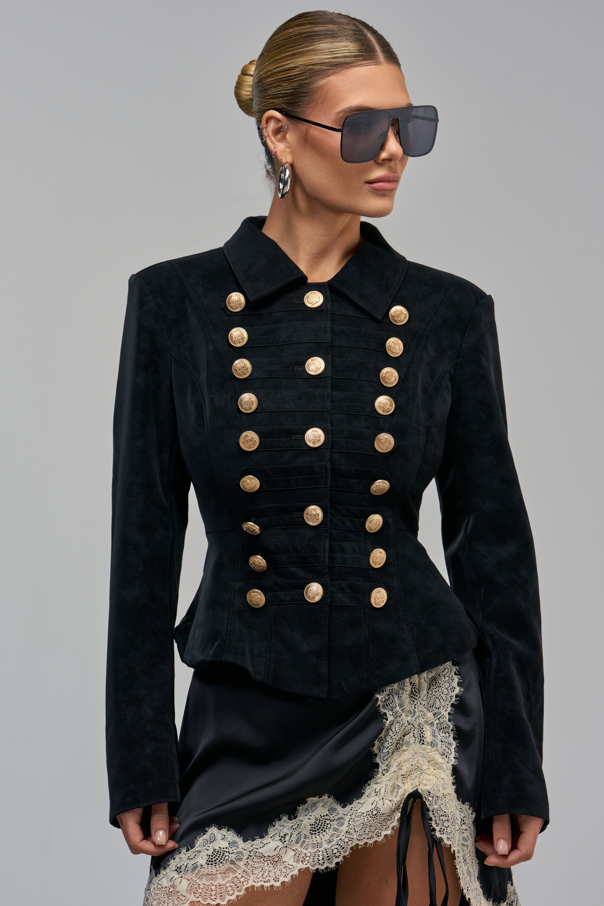 READY FOR IT PEPLUM JACKET in black, featuring a military-inspired design with long sleeves and two rows of metallic gold buttons.