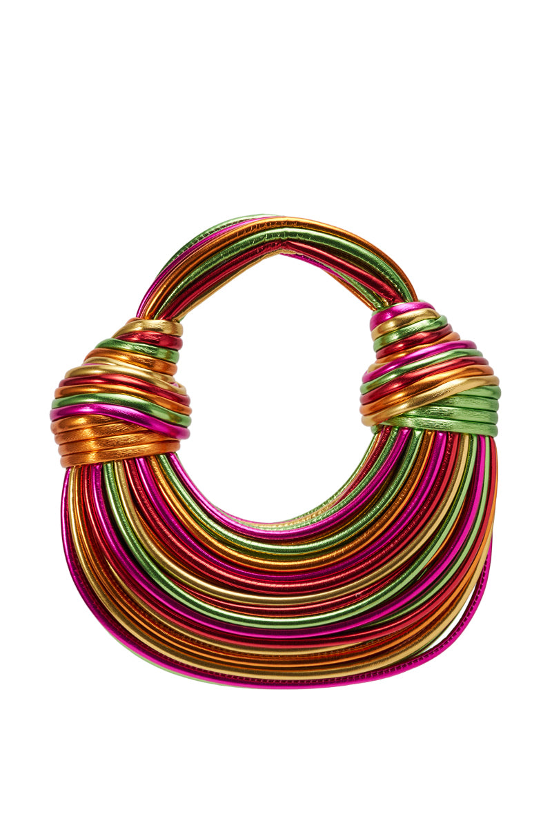 The COAST TO COAST ROPE PURSE is a sculptural metallic handbag with a rounded handle, wrapped in shiny pink, orange, green, and gold bands for a vibrant striped look—a standout faux leather accessory.