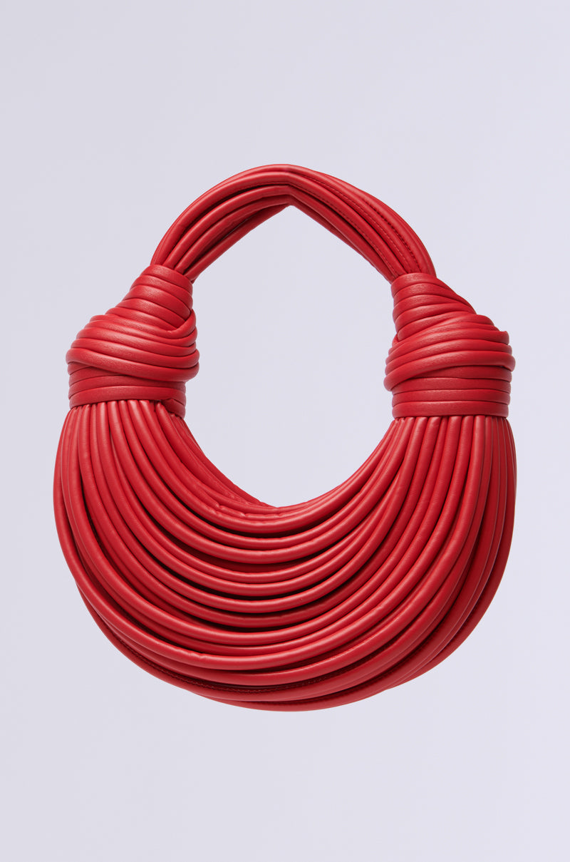 Introducing the RED HOT ROPE BAG, a statement piece crafted from intricately woven faux leather. Its unique layered design and textured surface offer a stylish and modern flair against any setting.