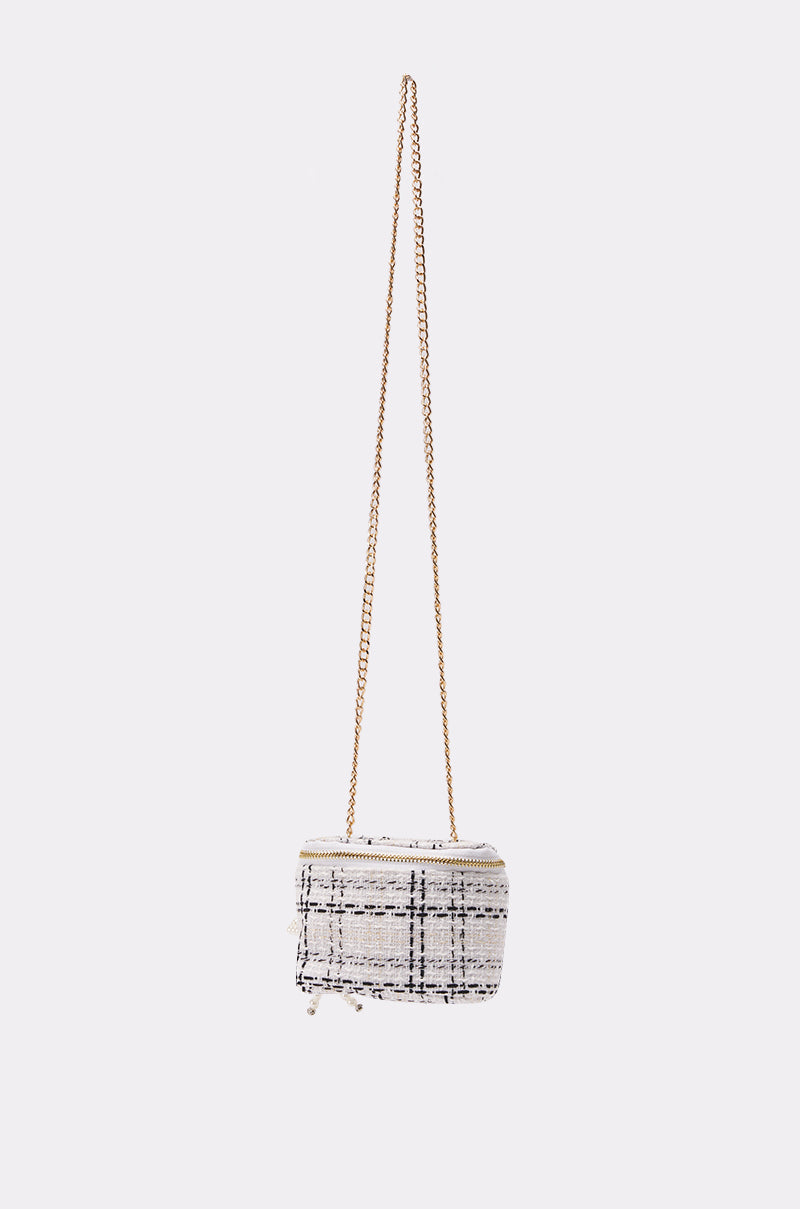 The PEARLICIOUS MINI BAG is a small rectangular tweed mini bag with a white and black plaid pattern and a gold chain shoulder strap, shown against a plain white background. 1