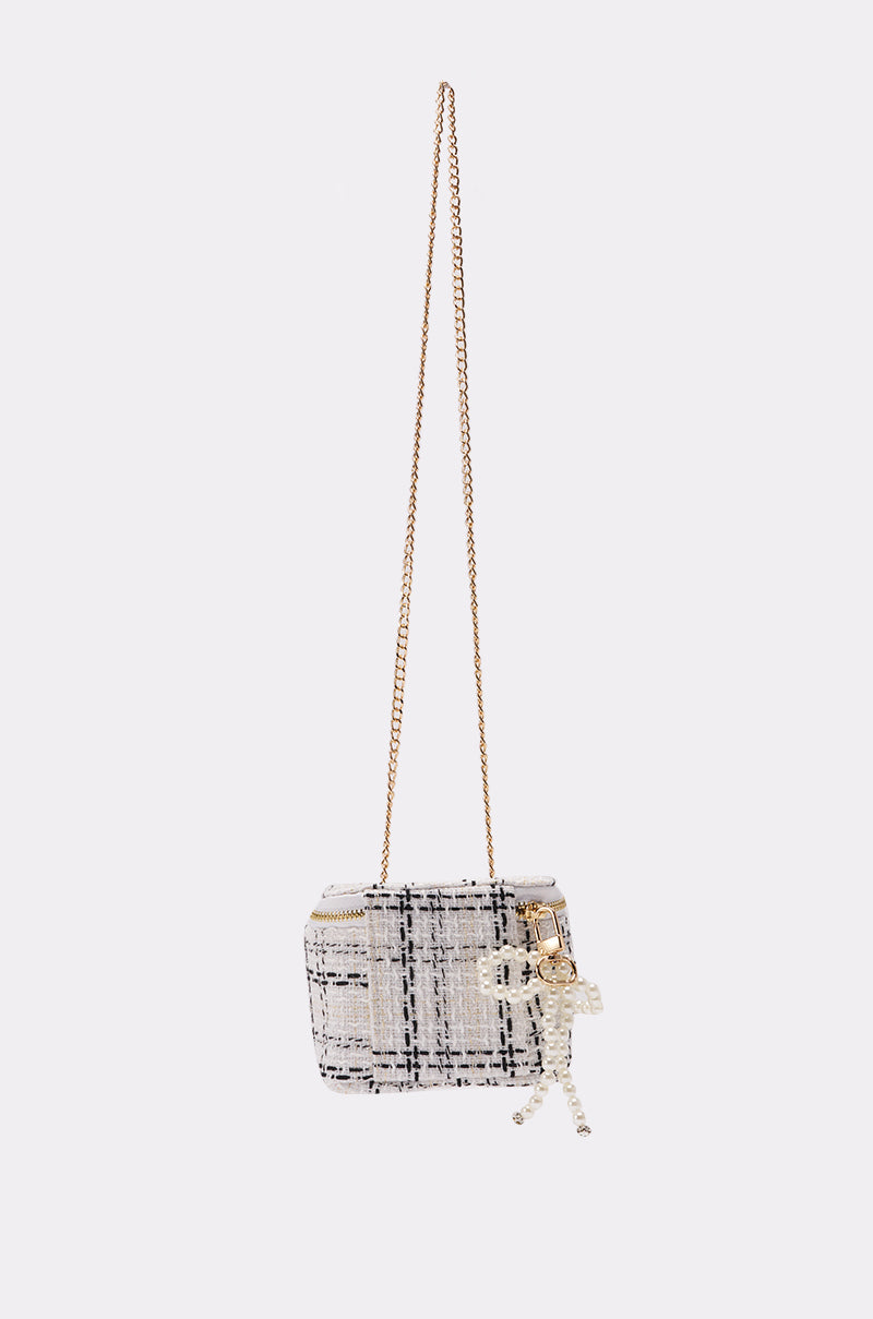 The PEARLICIOUS MINI BAG is a small rectangular tweed mini bag with a gold chain strap, beaded skeleton charm, and subtle pearl embellishments, shown against a plain white background.