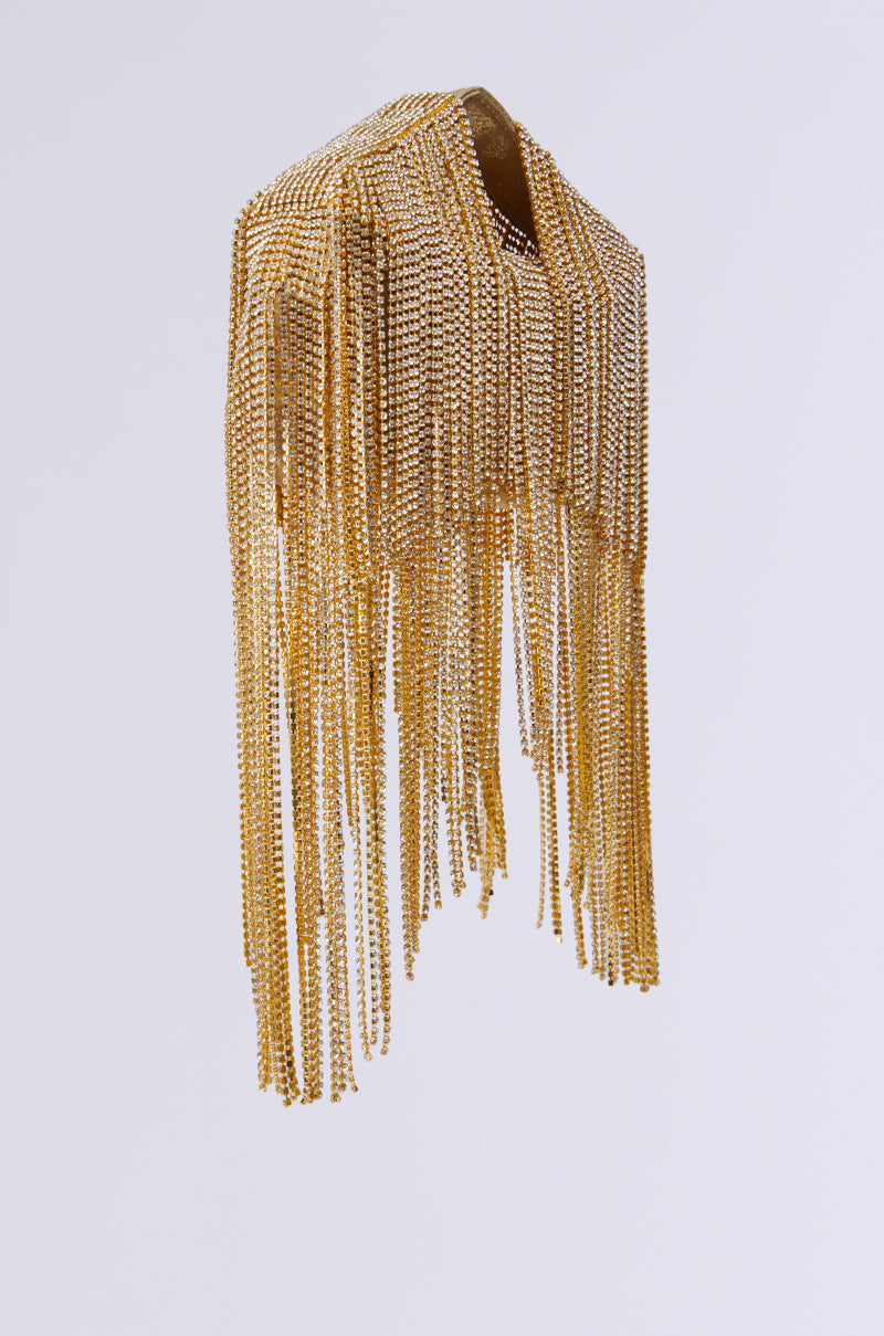Introducing the ULTIMATE LUXE BLING PURSE, a luxury accessory featuring a gold metallic chain harness adorned with layers of dangling chains that create a stunning rhinestone fringe effect, elegantly showcased against a plain white background.