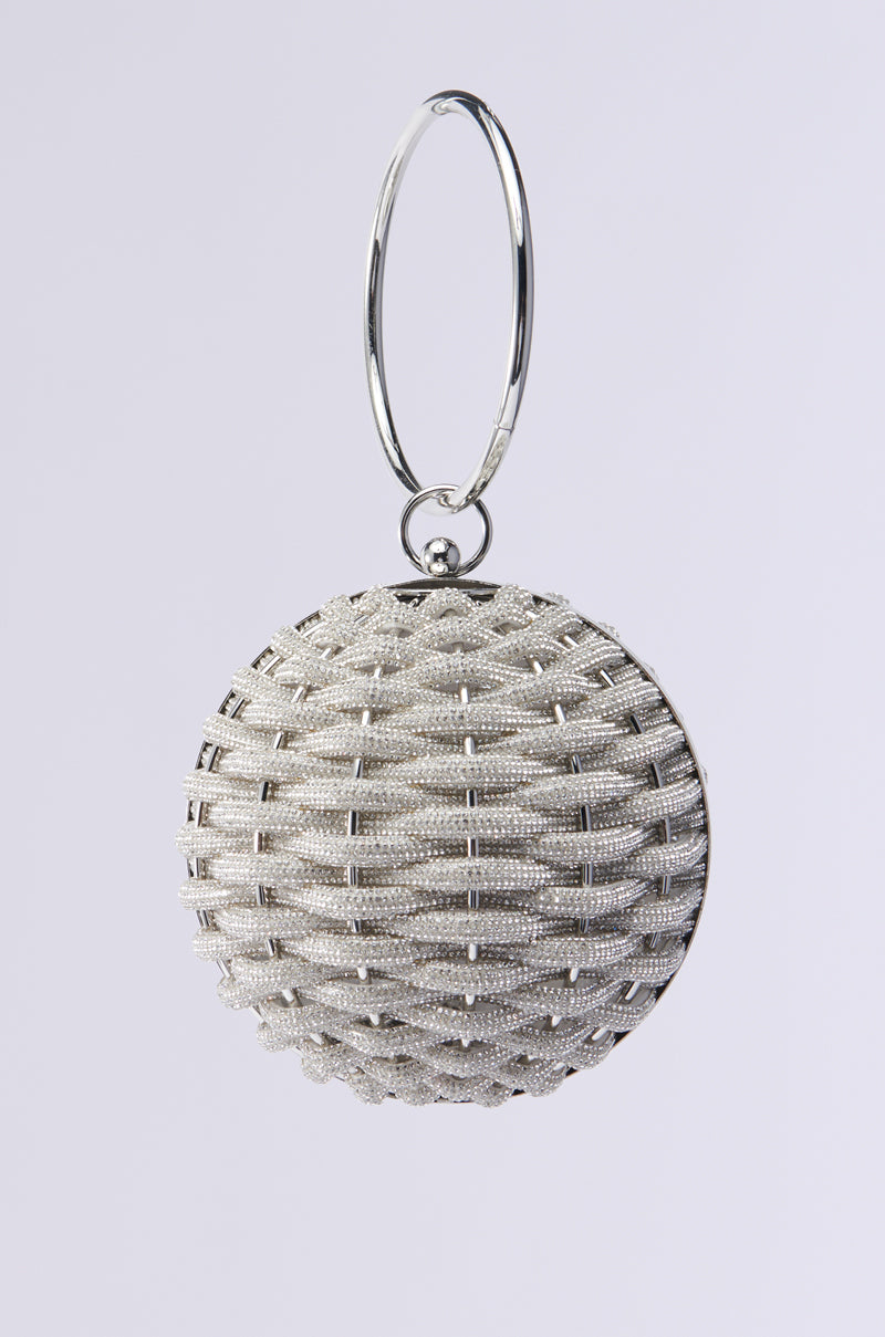 The DIAMONDS DRIPPIN SPHERE PURSE features a metallic woven lattice design with a circular loop for suspension. Its shiny silver-like texture and rhinestone embellishments create an intricate, reflective look against the plain white background. 1