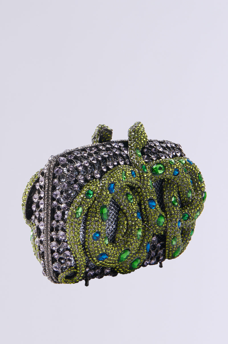 The IN THE GARDEN RHINESTONE CLUTCH is a bejeweled hardshell handbag with shimmering silver crystals and green and blue gemstones in an intricate leafy design. Its structured shape and top clasp stand out against the plain white background. 2