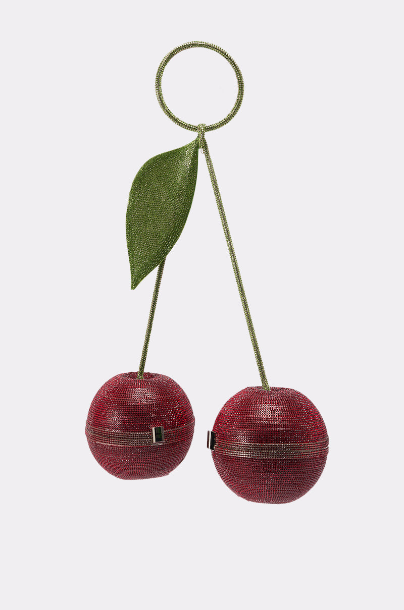 The POP MINE PURSE is a playful novelty handbag shaped like two sparkling red cherries with a green beaded leaf and handle, set against a plain white background. 3
