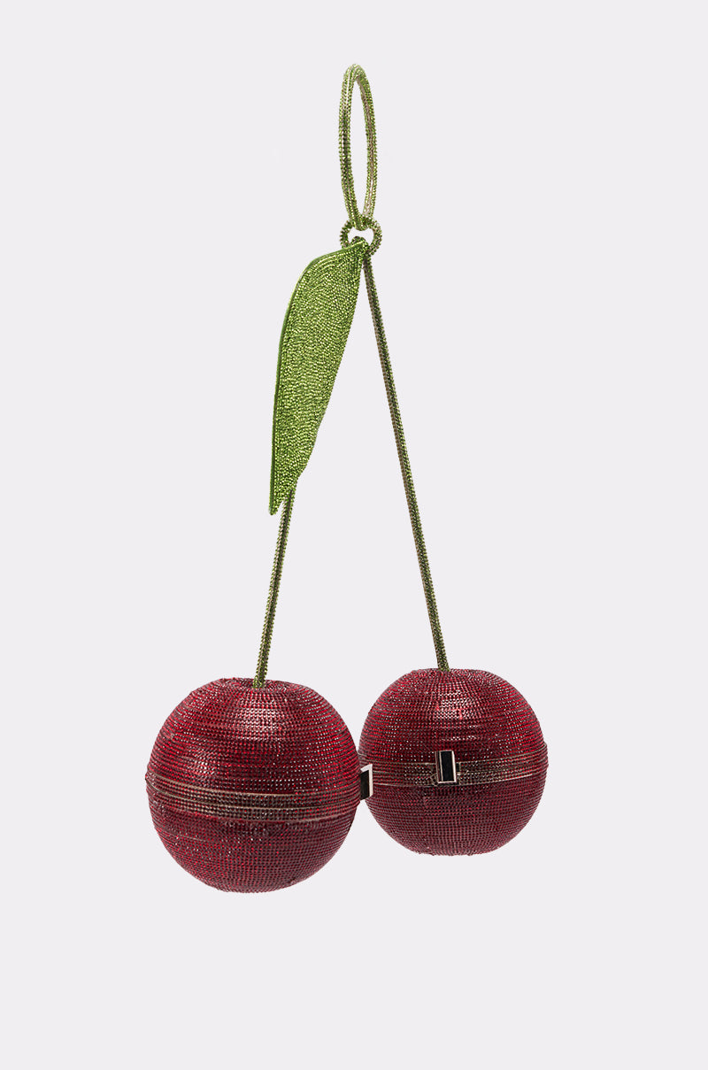 The POP MINE PURSE is a novelty handbag shaped like two rhinestone-studded red cherries, joined by a green stem and leaf. Each cherry has its own zippered compartment, shown together on a plain white background. 5
