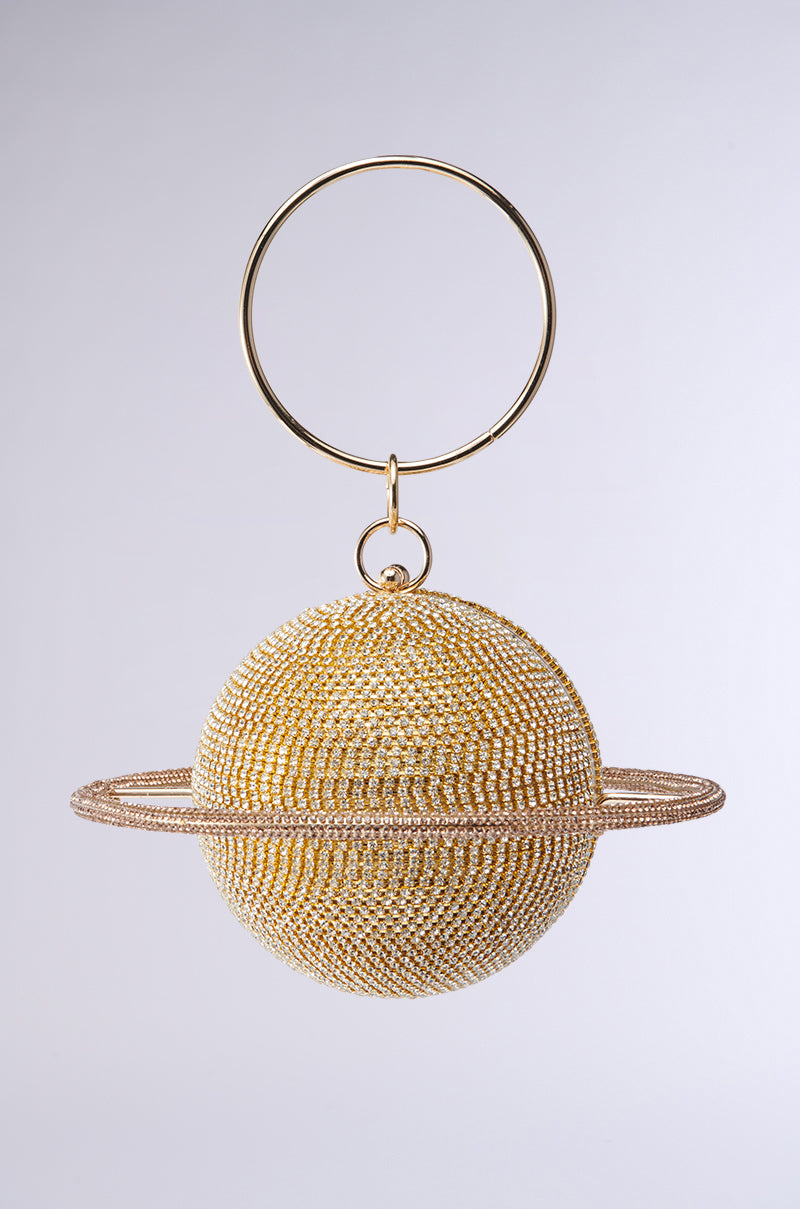 The OUTTA THIS WORLD PURSE features a gold Saturn-shaped keychain with rhinestone detailing and sparkling beads, making it a dazzling accessory for your gold metallic purse against a plain light background. 0