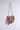 The ITS REALLY SWEET PURSE is a tapestry-style shoulder bag with red, blue, and green rose print on a pink background. It features a flap closure and silver chain strap, set against a plain light gray background.