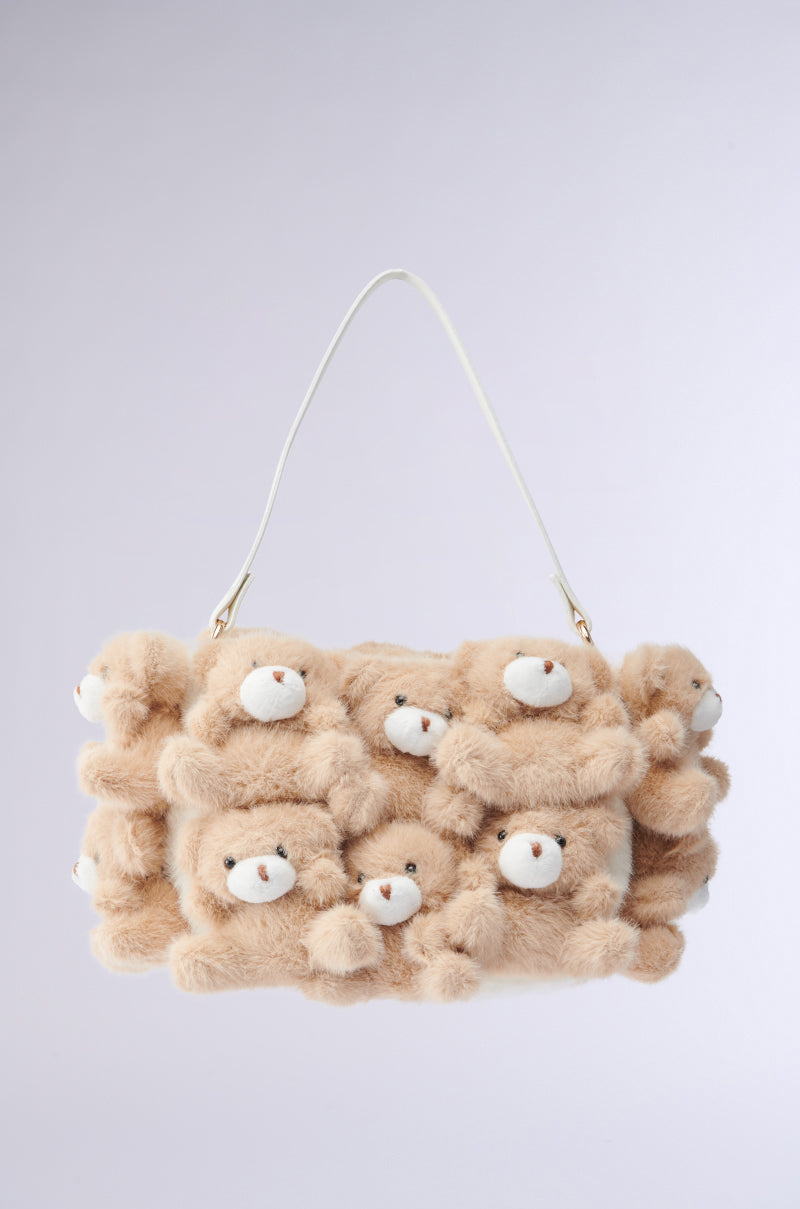 Introducing the BEAR WITH ME PURSE: a faux fur handbag with plush bear appliques, featuring cute beige teddies with white faces. This unique accessory has a white strap and light gray background, perfect for adding charm to any ensemble.
