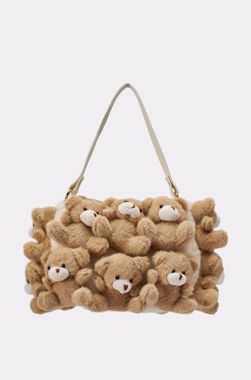The BEAR WITH ME PURSE is a rectangular purse with a white strap, covered in plush brown teddy bears packed closely together for a soft, whimsical look.