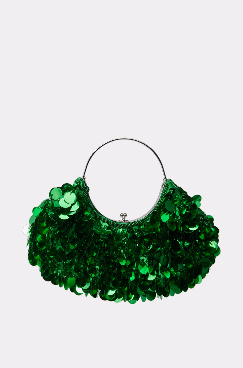 The GREEN WITH ENVY SEQUIN PURSE is a small bag with a round metal handle, featuring shiny, oversized green sequins for a textured, eye-catching look. Shown against a plain white background.