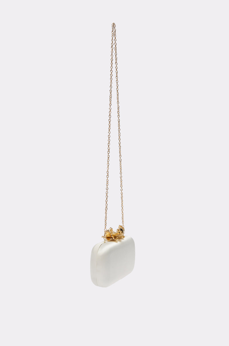 The IN ROME CLUTCH is a small, rectangular white clutch with a gold clasp and removable chain strap, shown against a plain light background. 5