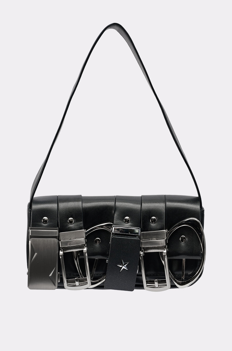 The BUCKLE UP PURSE is a black vegan leather, structured cylindrical bag with metallic hardware, multiple silver buckles, a star detail on the front, and a single wide strap.