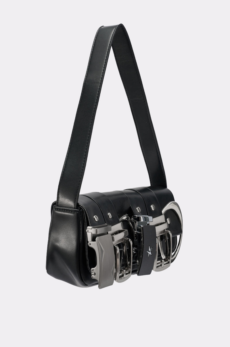 The BUCKLE UP PURSE is a black vegan leather bag with three bold silver buckles, a wide strap, and a modern structured shape. Chic metallic accents complete its contemporary look.