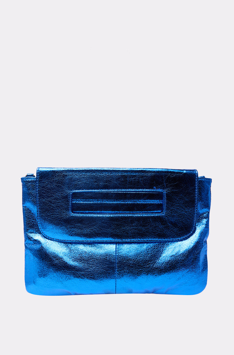 The COSMIC COBALT OVERSIZED CLUTCH, made from metallic blue faux leather with a rectangular flap and subtle stitching, is displayed on a plain light grey background.