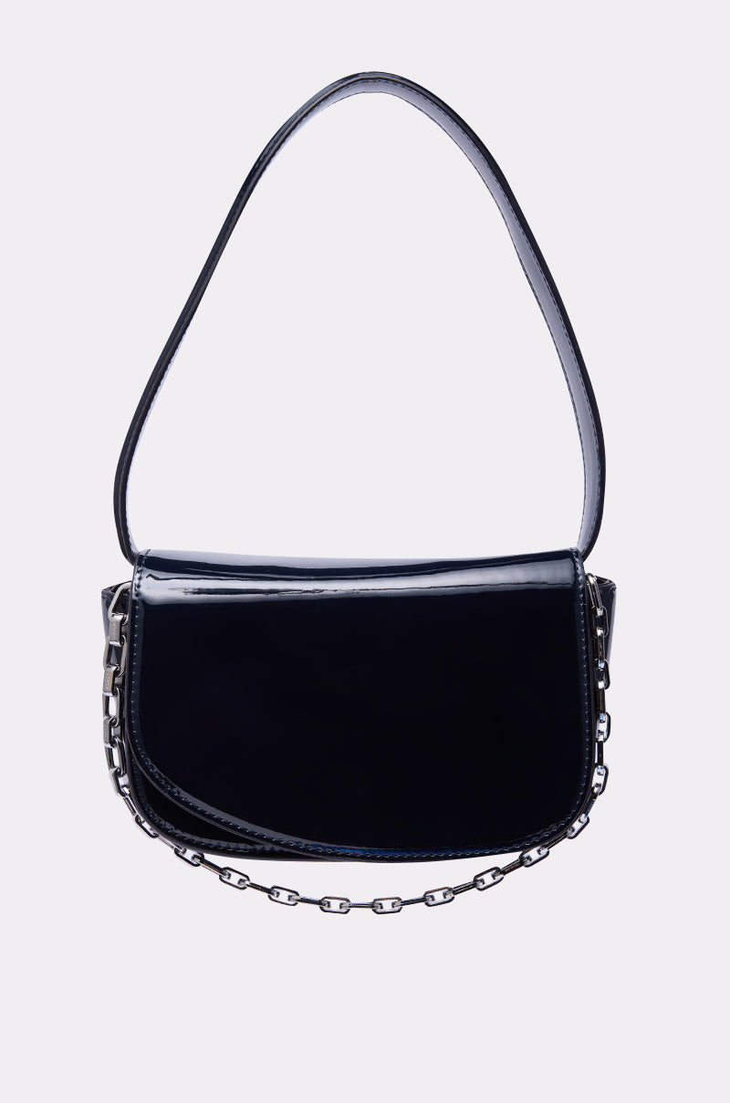 The WITH IT PATENT PURSE is a glossy black mini-bag crafted from sleek faux patent leather, featuring a curved flap, short shoulder strap, and a decorative silver chain along the bottom edge. 1