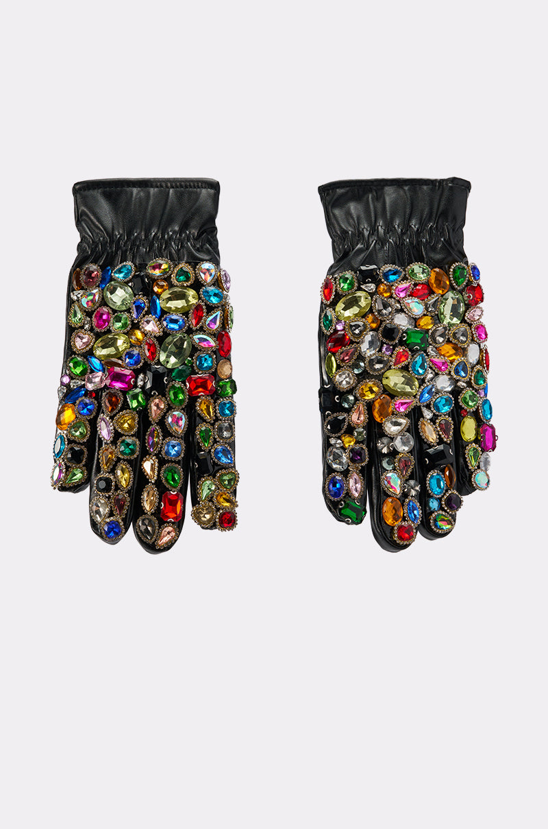 The LOVE YOU BLING GLOVES are black faux leather gloves decorated with colorful, oversized rhinestones and gems clustered densely on the tops and fingers, shown against a plain white background.