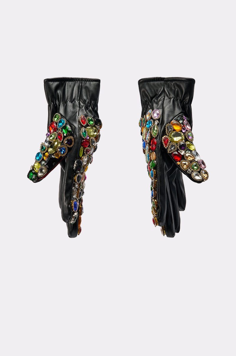 The LOVE YOU BLING GLOVES are black faux leather gloves decorated with clusters of large, colorful gemstone embellishments on the tops and fingers, shown against a plain white background. 2