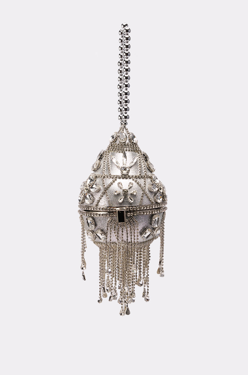 The DECO BLING BAG is a silver, egg-shaped clutch with rhinestones, crystal fringe tassels, intricate patterns, and a beaded handle—a striking statement accessory displayed on a plain white background.