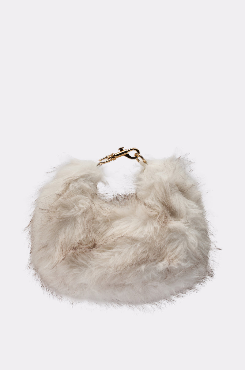 The WINTER SKY FAUX FUR PURSE is a chic soft white handbag with light brown streaks, a short handle, and gold clasp—perfect for winter and shown against a plain light background. 0