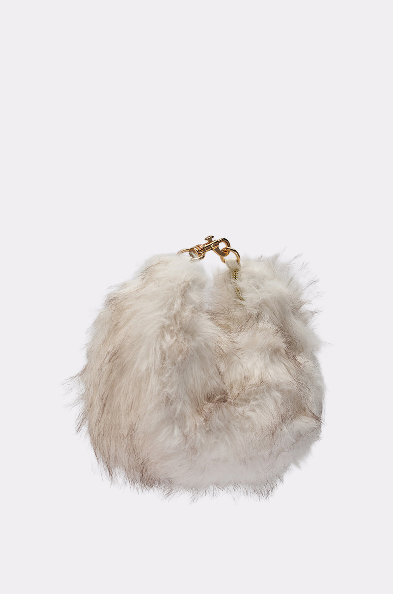The WINTER SKY FAUX FUR PURSE is a round, fluffy winter bag featuring soft, light-colored faux fur with a gold clasp and handle, displayed against a plain white background. 2