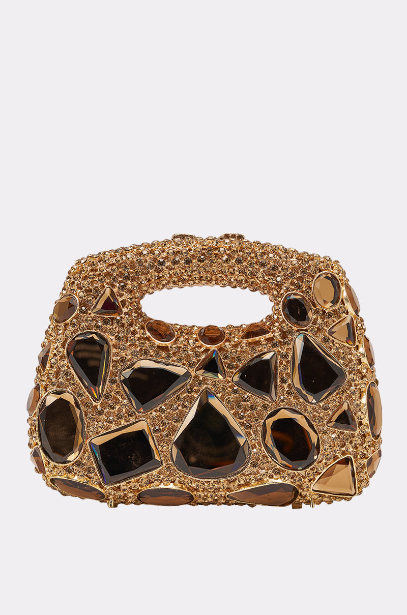 The EVA BLING BAG is a gold clutch evening bag featuring large geometric black and gold gemstones and a textured handle, displayed on a plain white background. 1