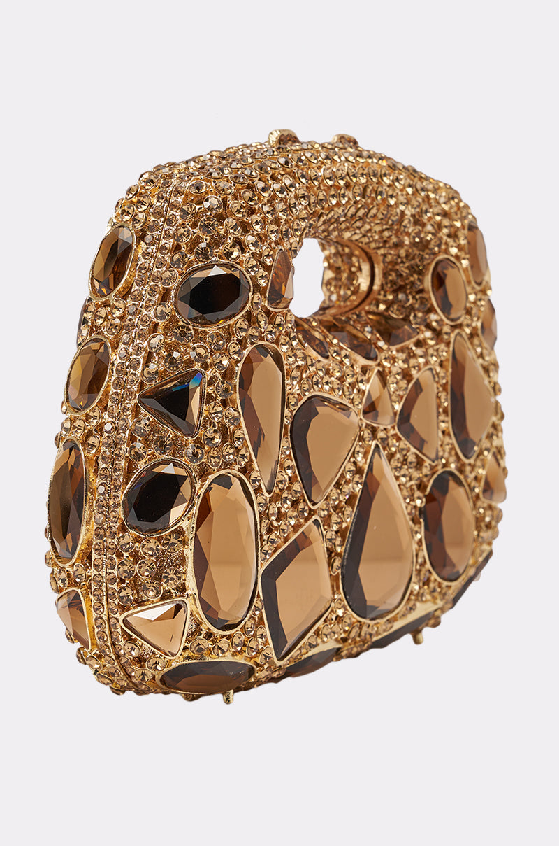 The EVA BLING BAG is a gold clutch purse adorned with large and small brown gemstones in various shapes. This elegant rhinestone mini handbag features a top cut-out handle for easy carrying and a shimmering, ornate design. 4