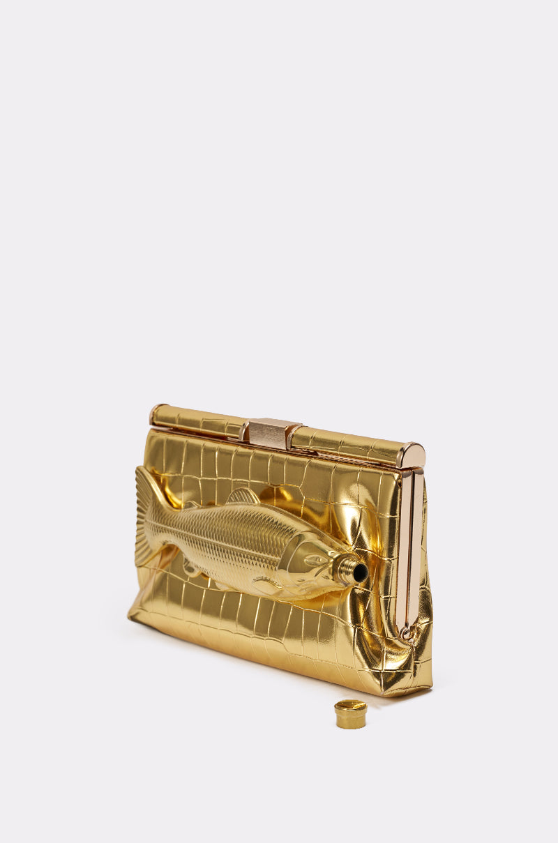 The GONE FISHIN CLUTCH is a gold croc-embossed faux leather bag with a detailed fish design on the front, shown with a small gold cylindrical cap on a plain white background. 4