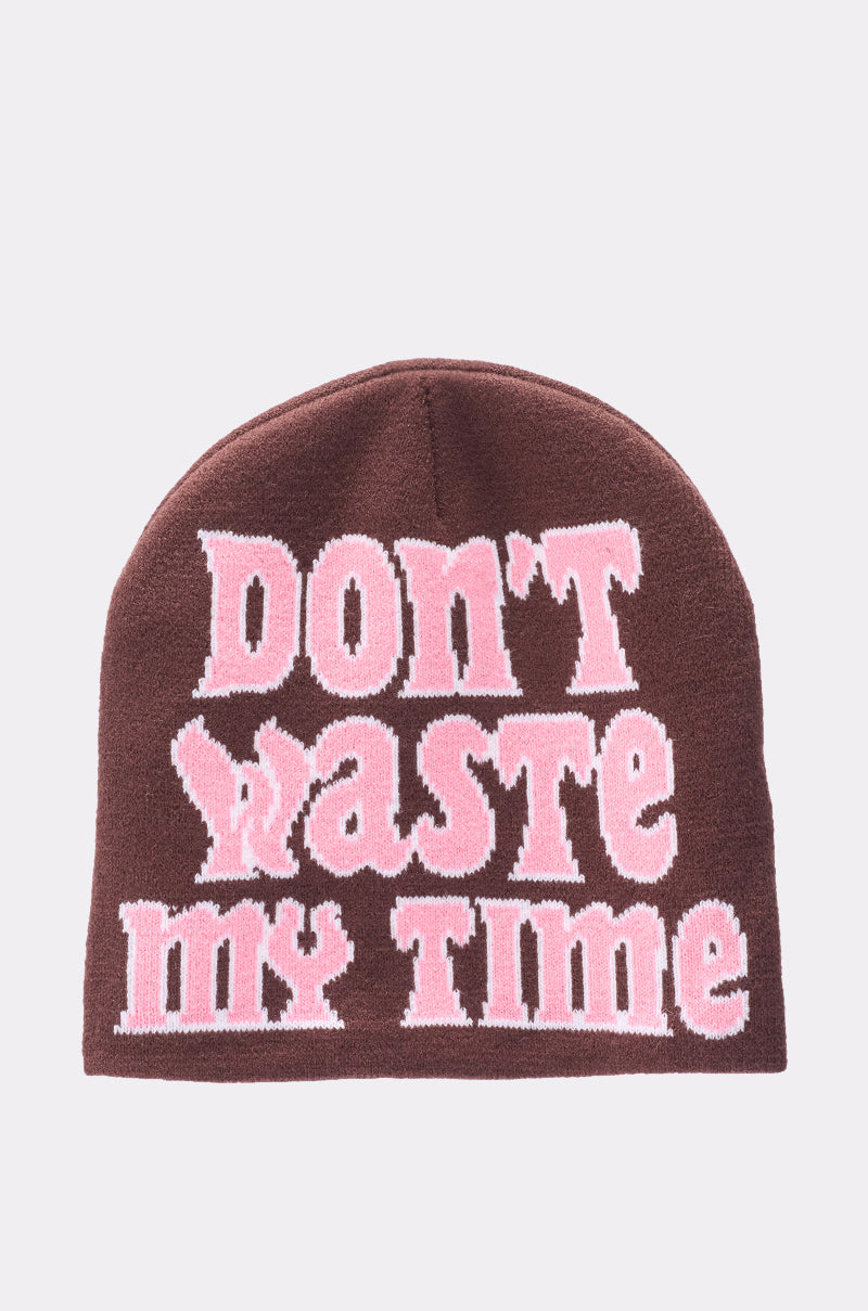 A dark brown knit hat with bold, large pink and white text that reads, "IM SO FORREAL BEANIE. 1