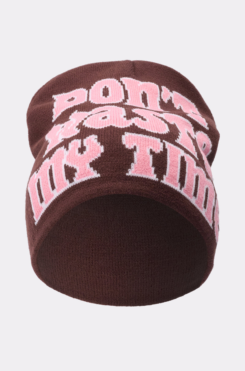 The IM SO FORREAL BEANIE is a brown knit beanie with bold pink and white "DON'T WASTE MY TIME" text on the front. 2