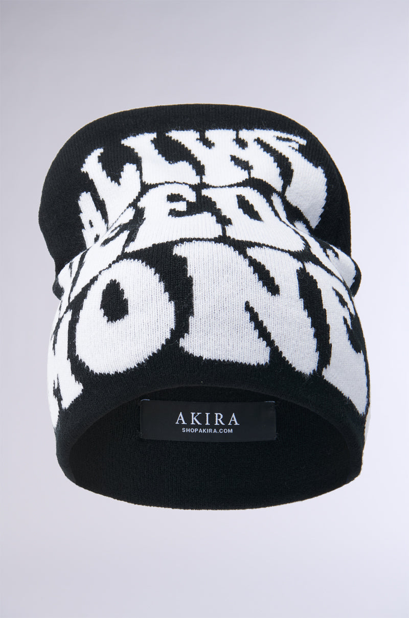 The ALL WE NEED IS MONEY Black Beanie is a cozy acrylic knit hat with bold white text partially visible for a mysterious allure. It features a small label reading "AKIRA, SHOPAKIRA.COM" at the base, perfect for stylish warmth on cold days. 3